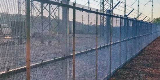 Anti-cut security fence installed around high-voltage utility site.