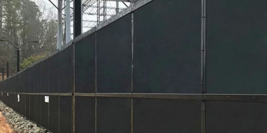 Ballistic Security Fence Installation for Maximum Threat Protection. Ballistic-rated security fence installation around high-risk infrastructure site.
