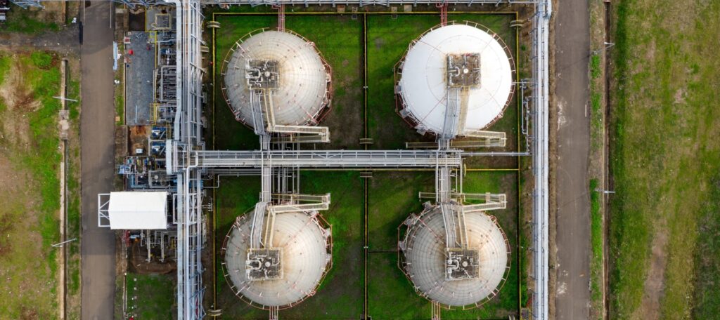 Aerial view of secured chemical plant facility with perimeter fencing.