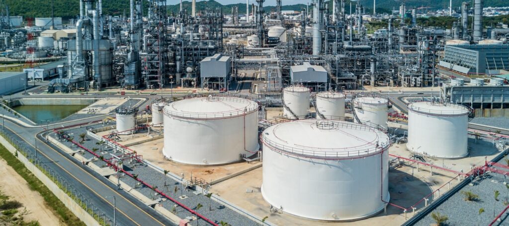 Aerial view of oil and gas facility with perimeter security fencing.