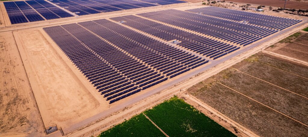 Aerial view of solar farm protected by perimeter security fencing.