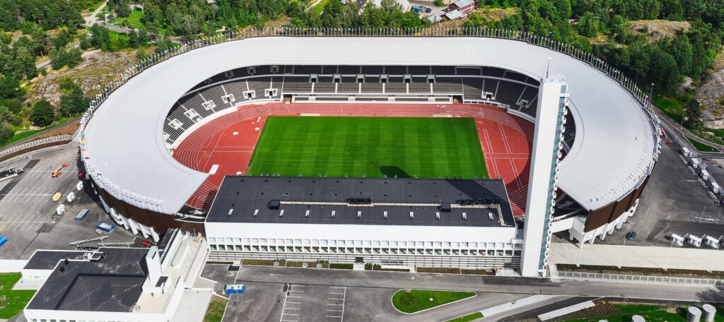 Aerial view of a secured sports stadium with perimeter fencing.
