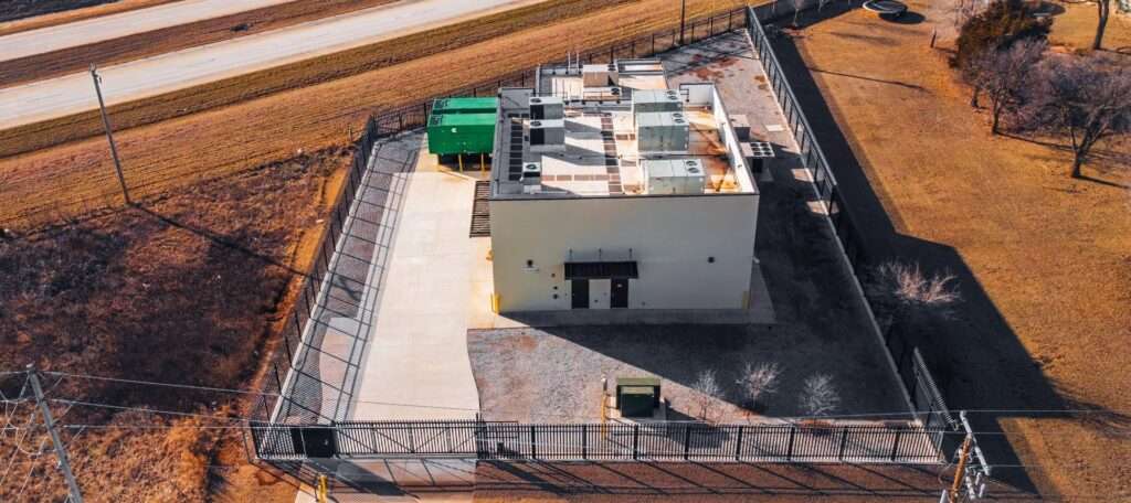 Aerial view of secured critical infrastructure site with perimeter fencing.