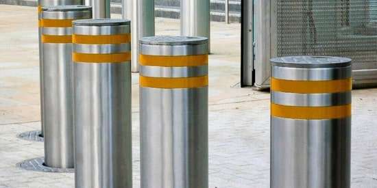 Crash-rated bollard installation for vehicle impact protection at secure facilities.