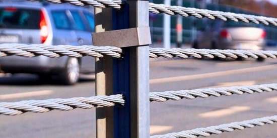 Fixed cable barrier installation for vehicle impact protection on high-security perimeters.
