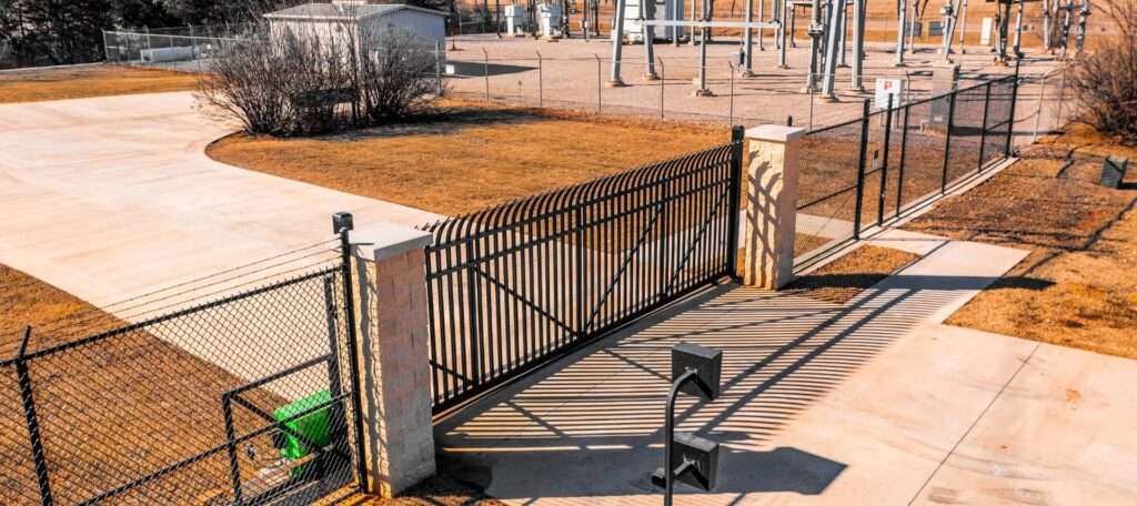 Secure perimeter fencing around high-voltage utility infrastructure.