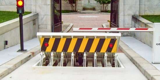 Wedge barrier installation for vehicle crash protection at high-security access points.